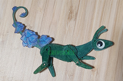 A feral green shrinky dink creature