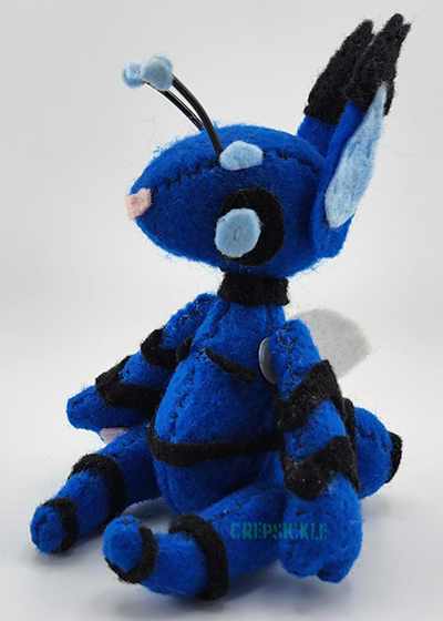 A blue bug creature with black stripes