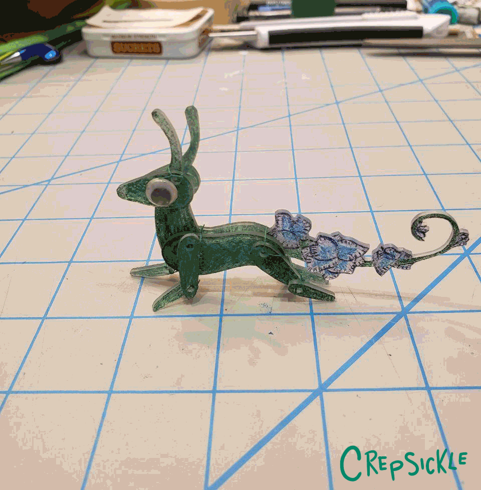 A stop motion animated feral green shrinky dink creature