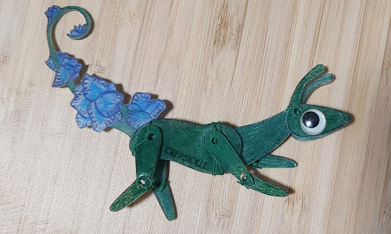 A feral green shrinky dink creature
