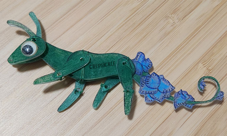 A feral green shrinky dink creature