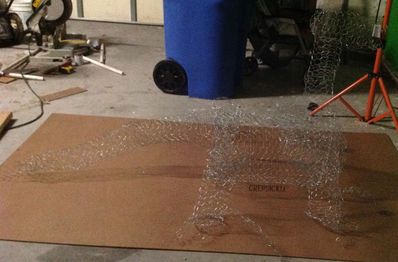 A large white paper mache lizard like creature